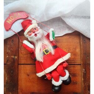 Vintage rubber face Santa on a swing decoration